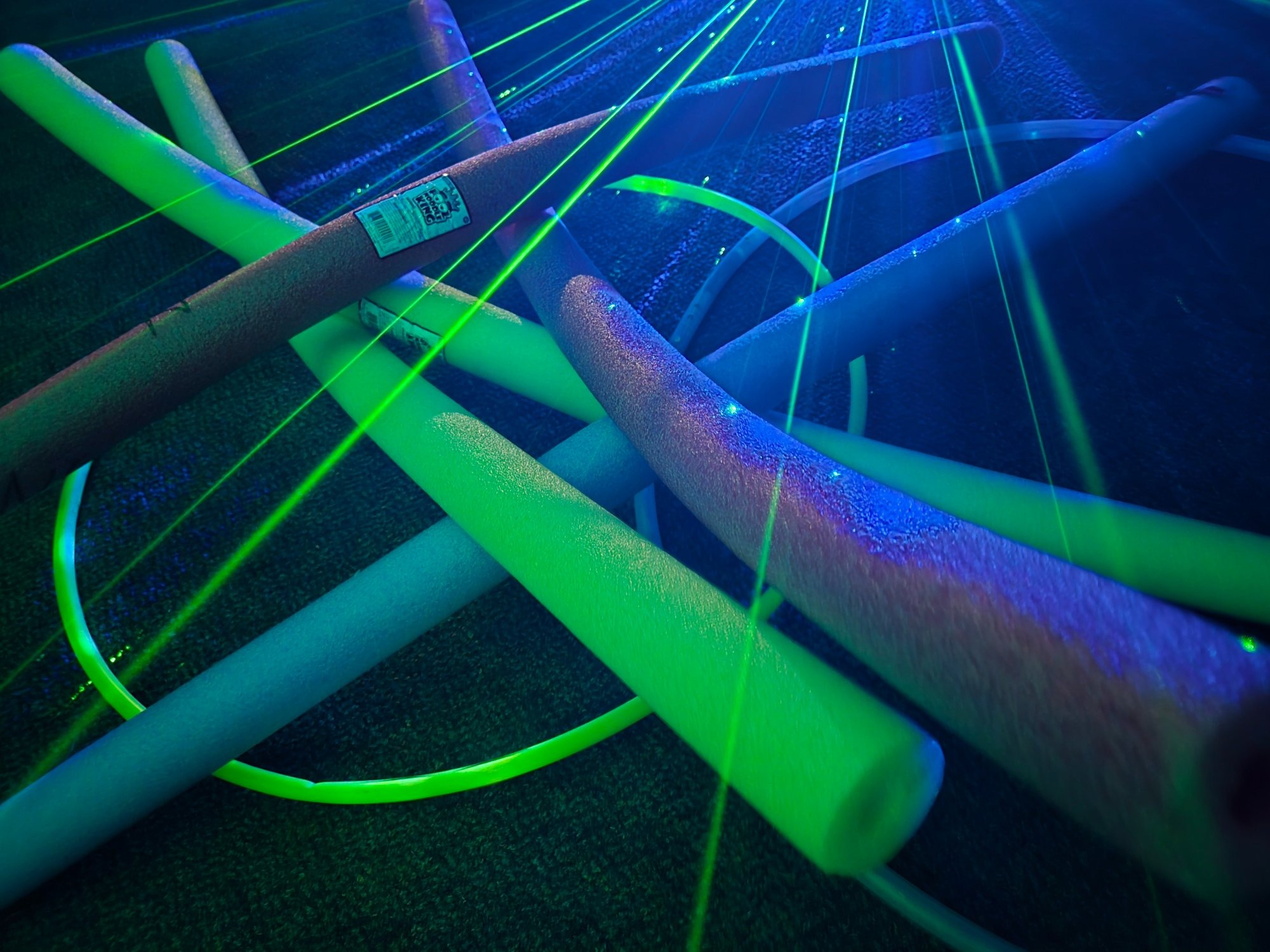DJNUDLZ branded pool noodles at a live event